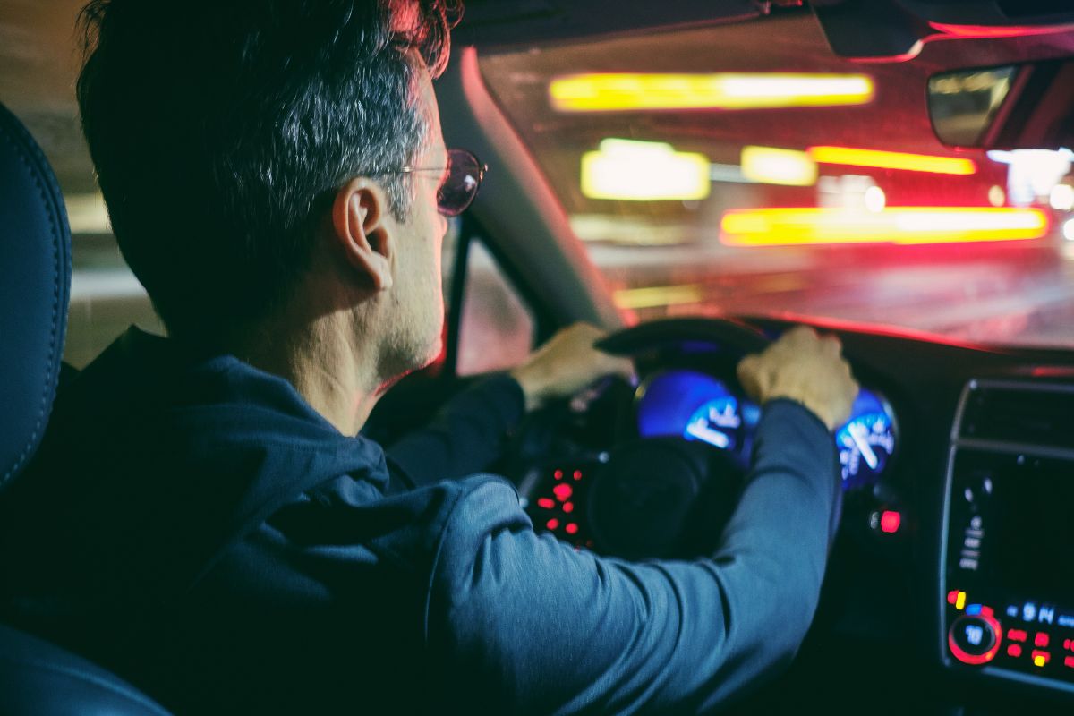 A picture of someone driving at night. 