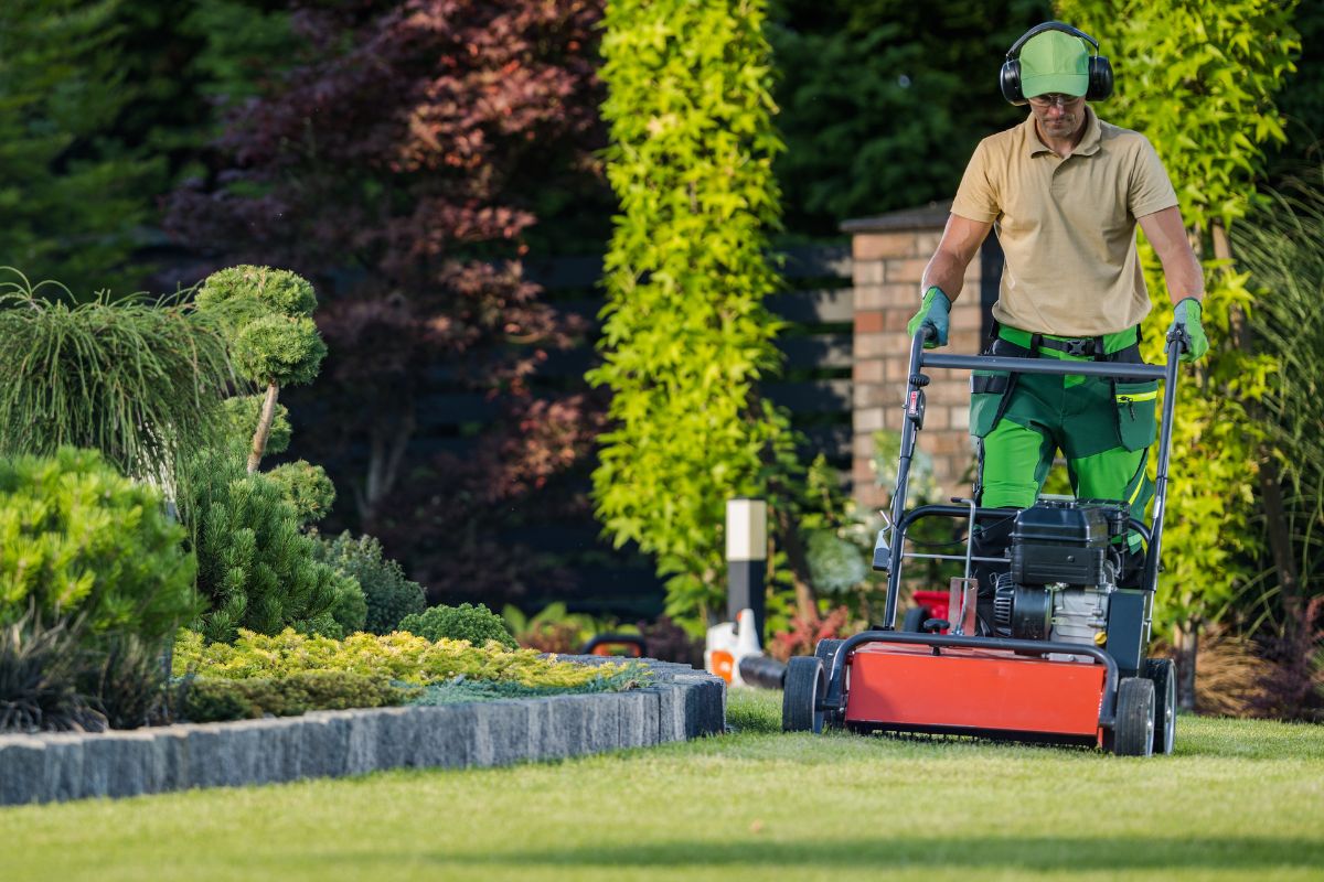 A picture of someone mowing lawn.