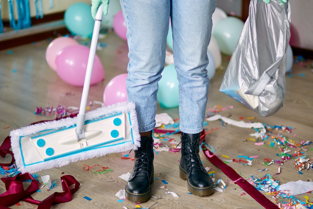 A picture of someone cleaning up a party venue. 