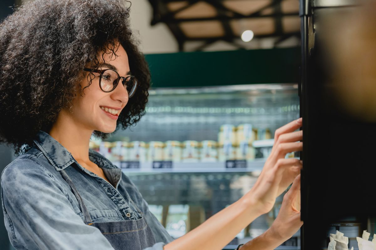 A picture of someone using a vending machine. 