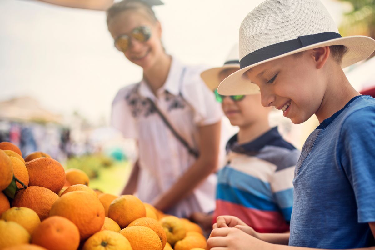 A photo of a family in a farmer's market. 
