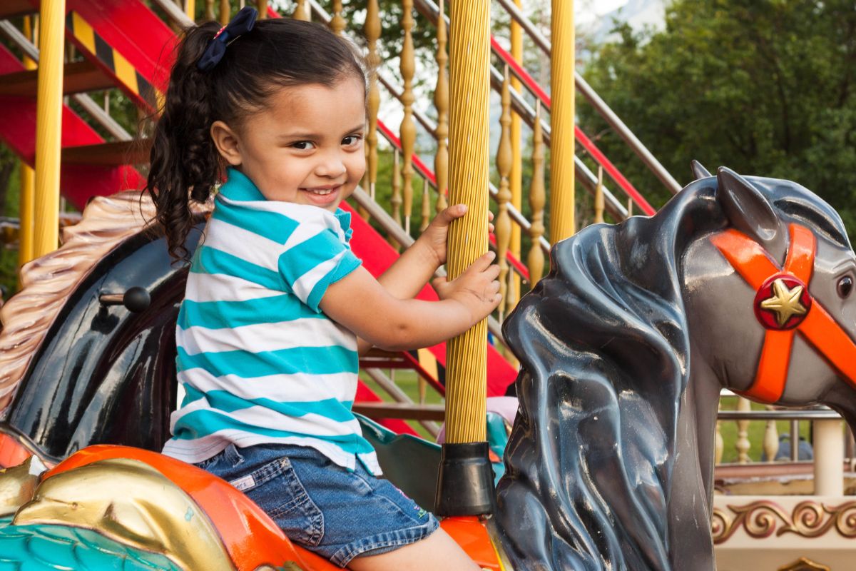 A picture of a child on a carousel. 