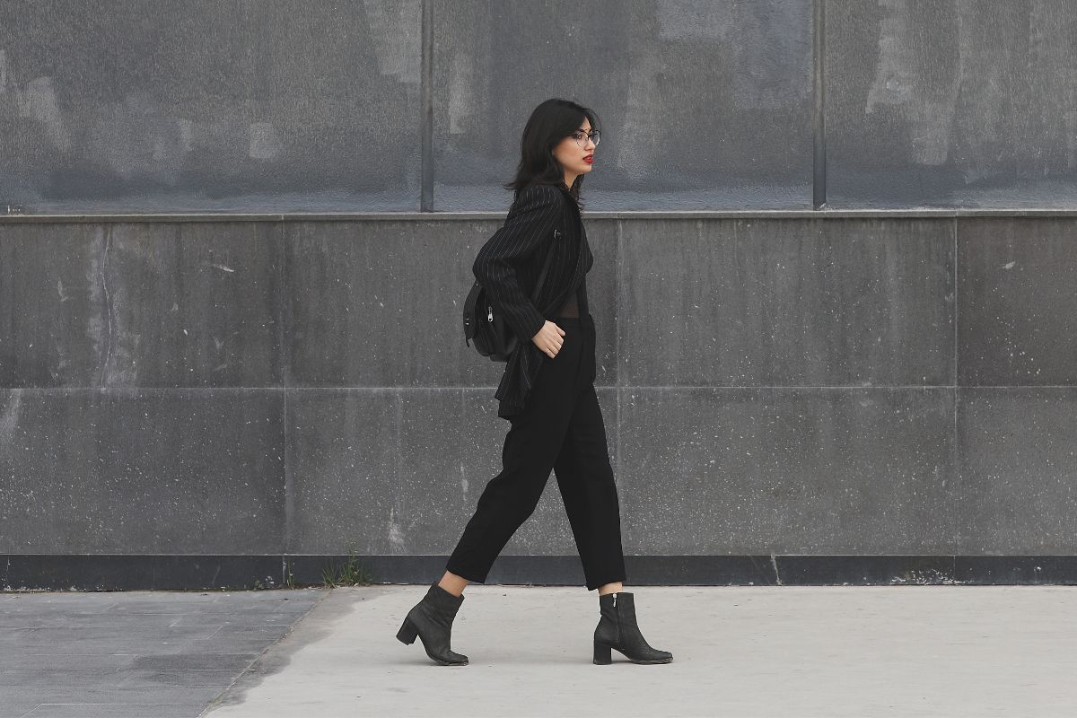 A picture of someone walking to her destination. 
