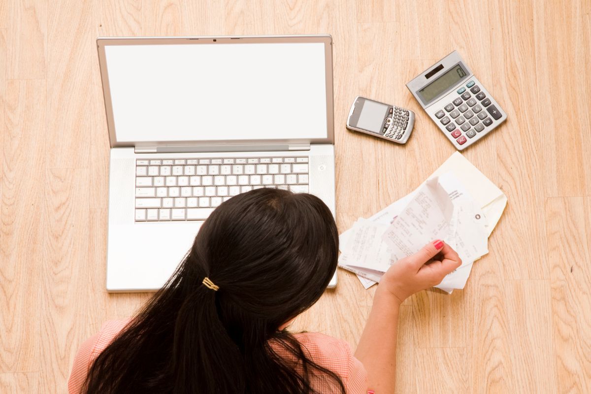 A picture of someone relaxing and tracking expenses.