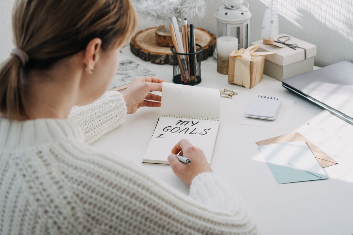 Picture of a lady creating a list of goals.