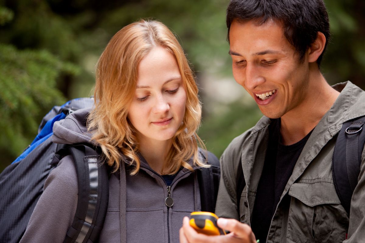 Picture of two people geocaching. 