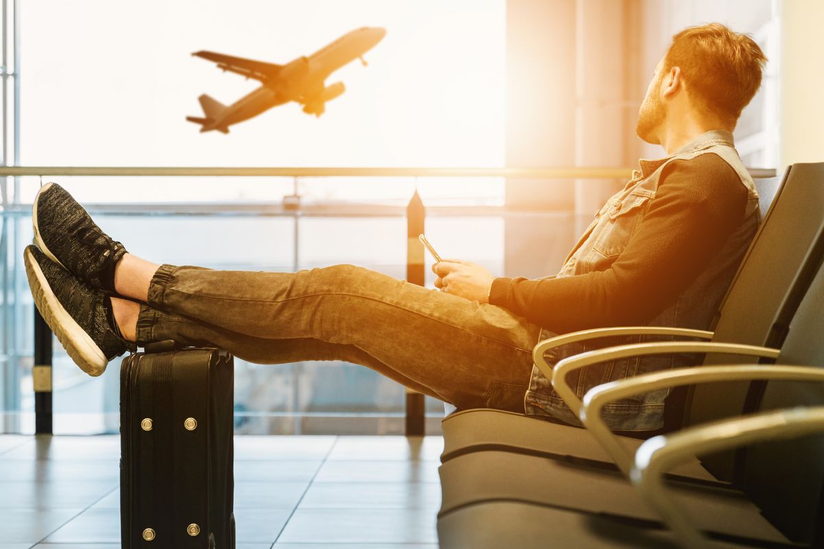A picture of someone looking at a plane outside. 