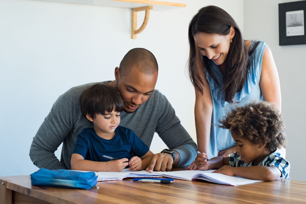 Picture of parents helping children in their studies. 