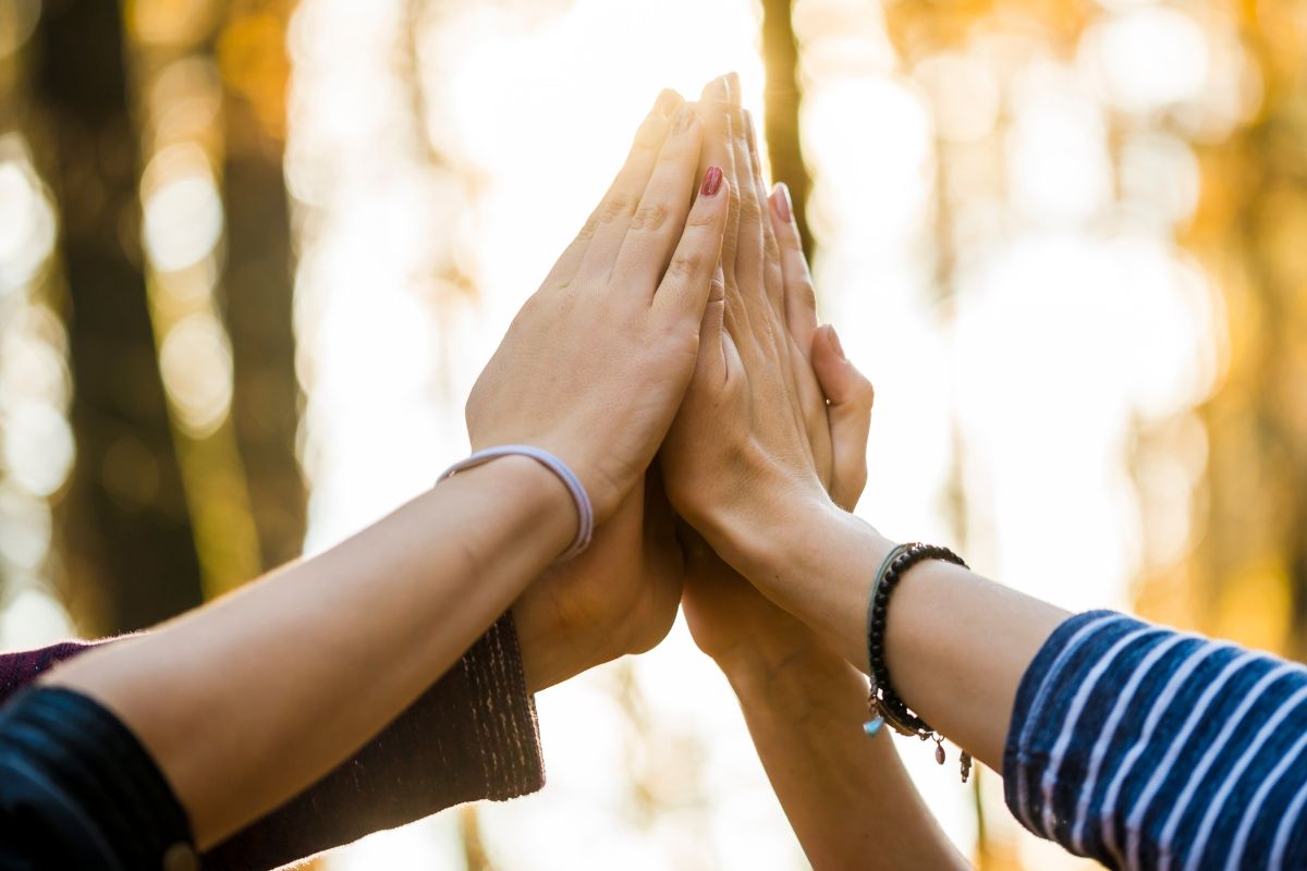 Picture of a group high five. 