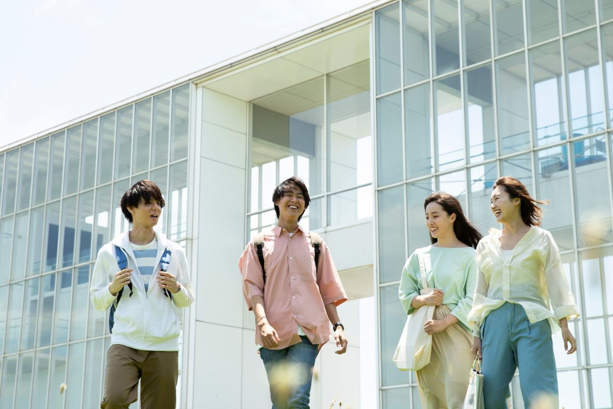 Picture of friends laughing while walking. 