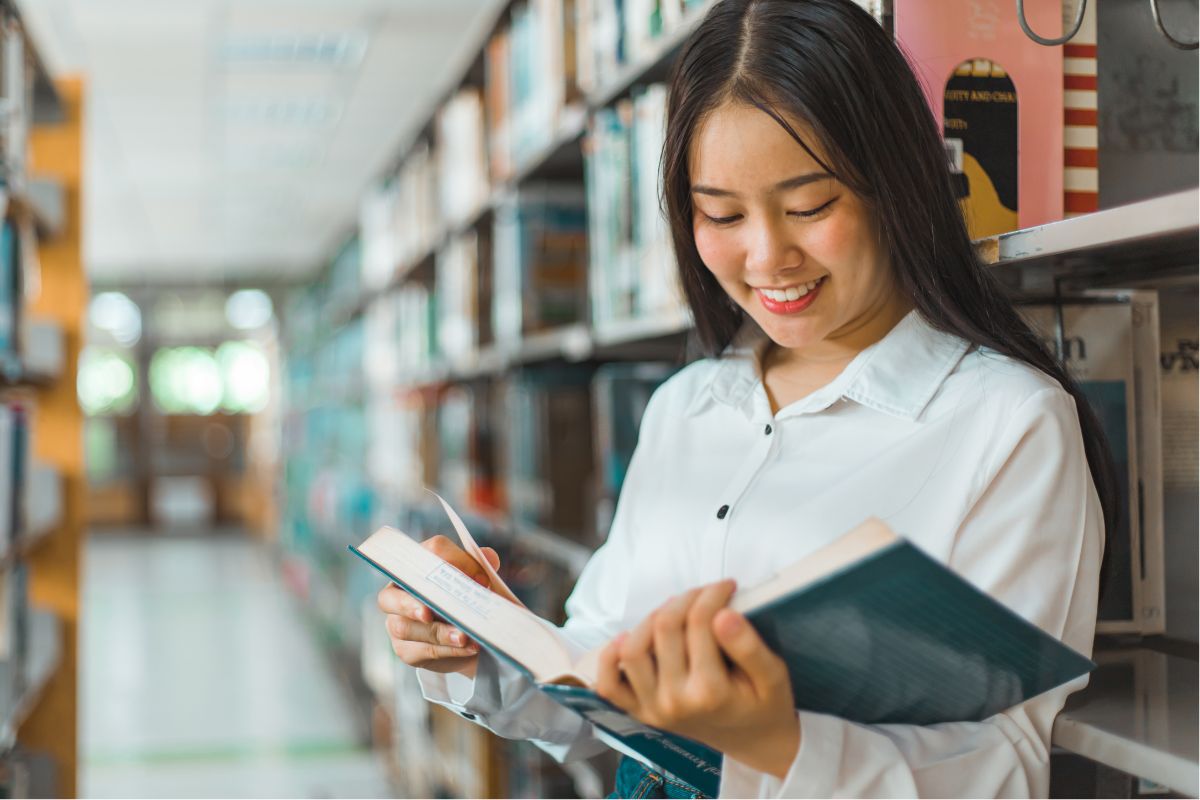 A picture of someone reading at a library.
