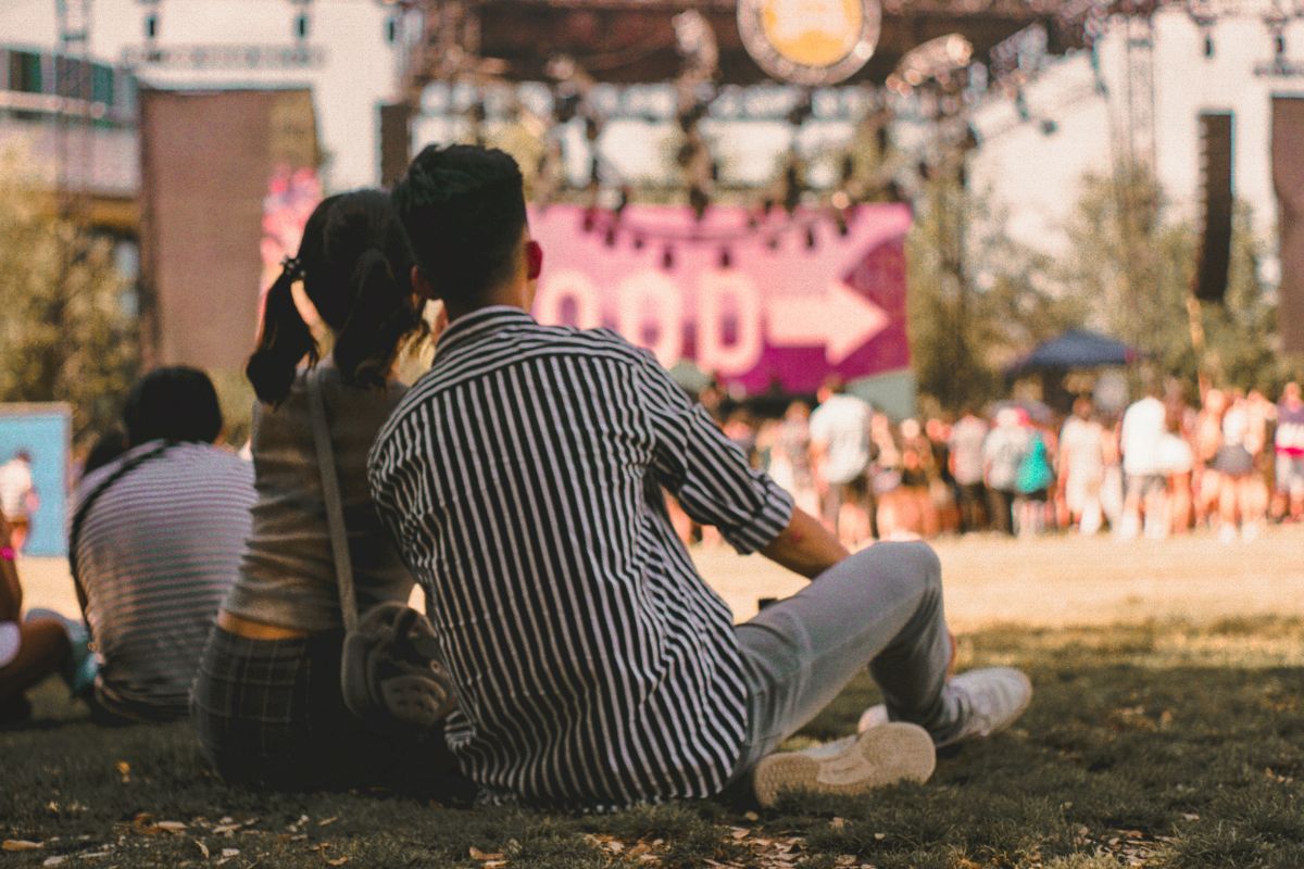 A picture of a concert at a park. 