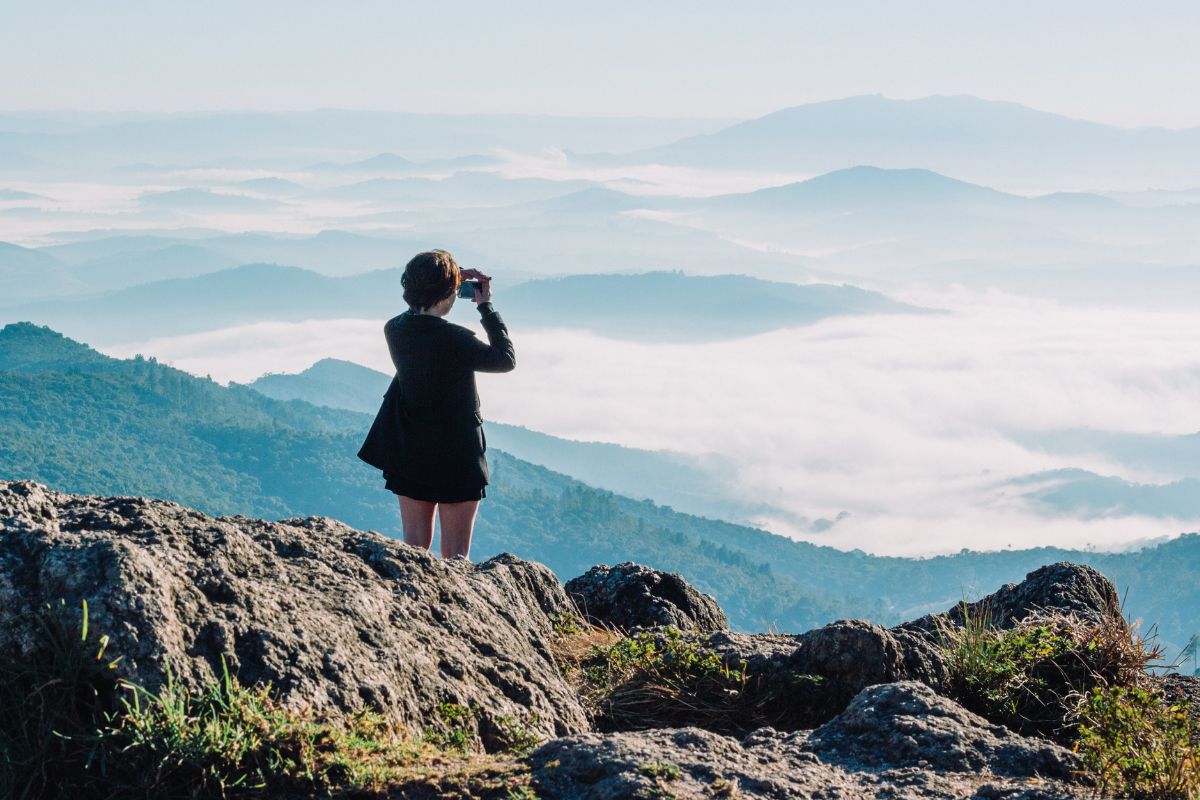 A picture of someone photographing the sky. 