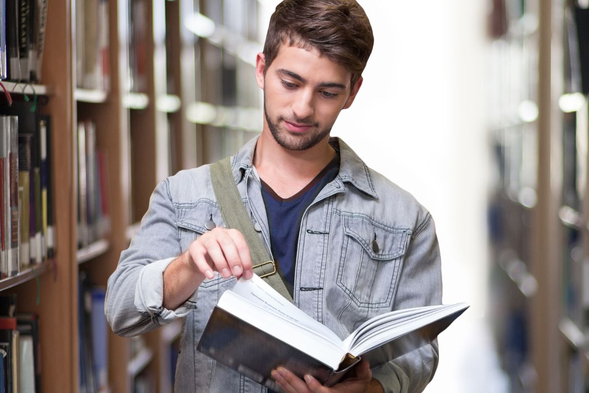 A picture of someone reading at a library. 