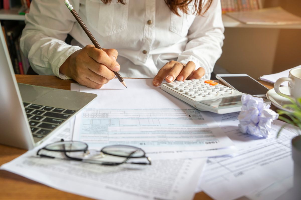 A picture of someone writing their finances.