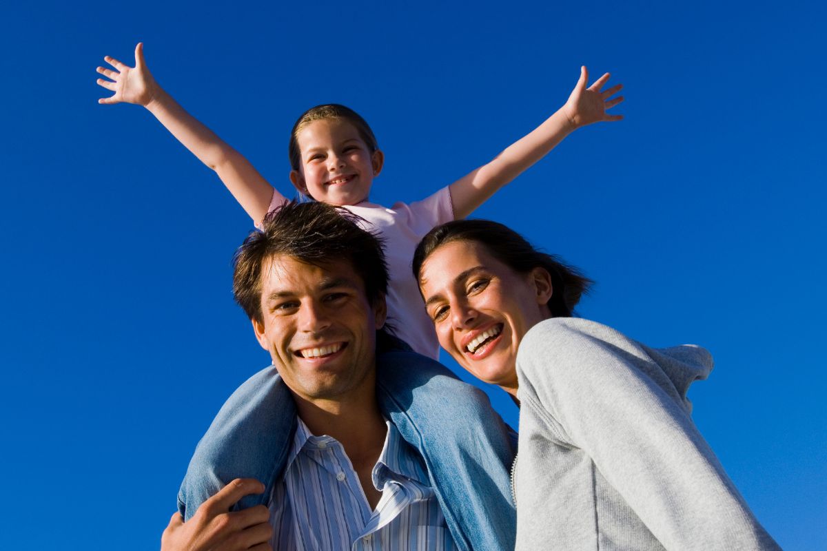 A picture of a family smiling. 