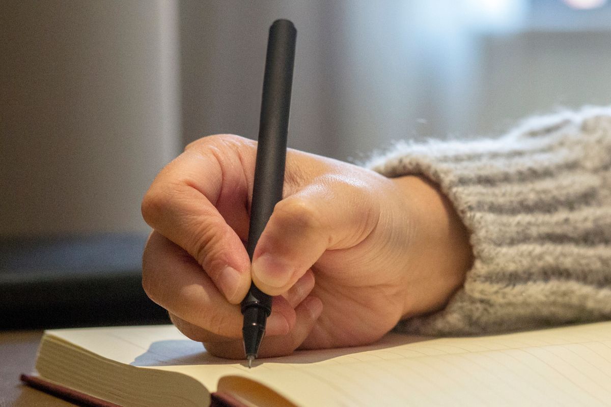 A picture of someone writing. 