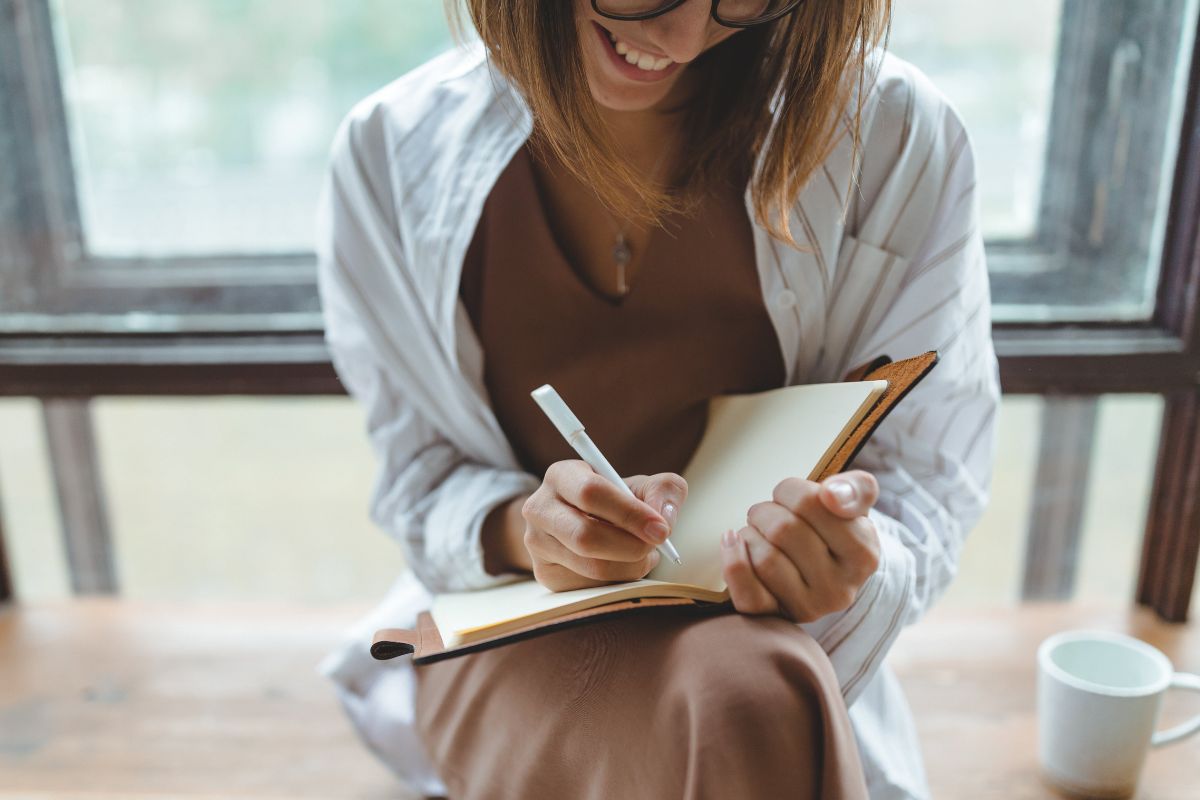 A picture of someone writing something down. 