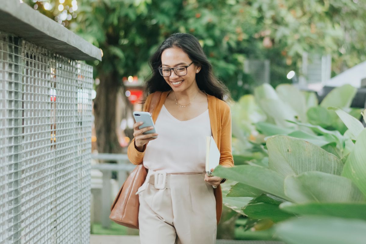 A picture of someone happily checking their phone. 
