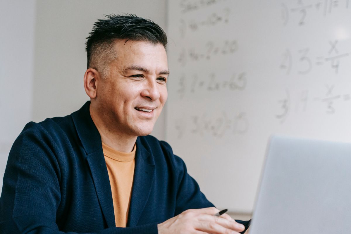 A picture of someone looking at his laptop. 