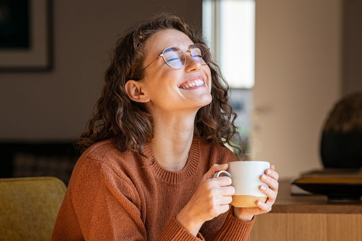 A picture of someone drinking coffee in their home. 
