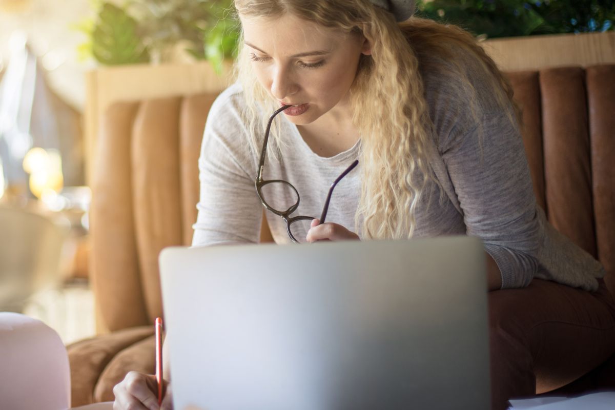A picture of someone writing down something. 