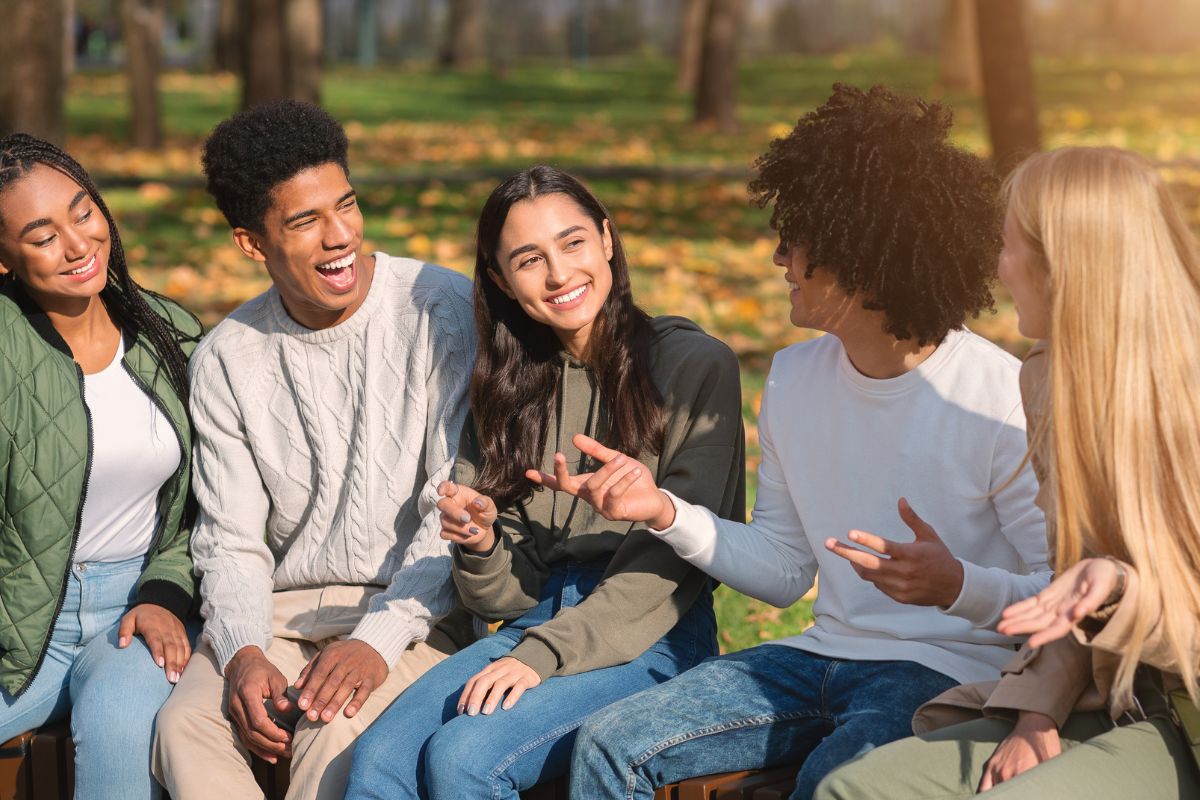 A picture of someone telling their friends a story. 