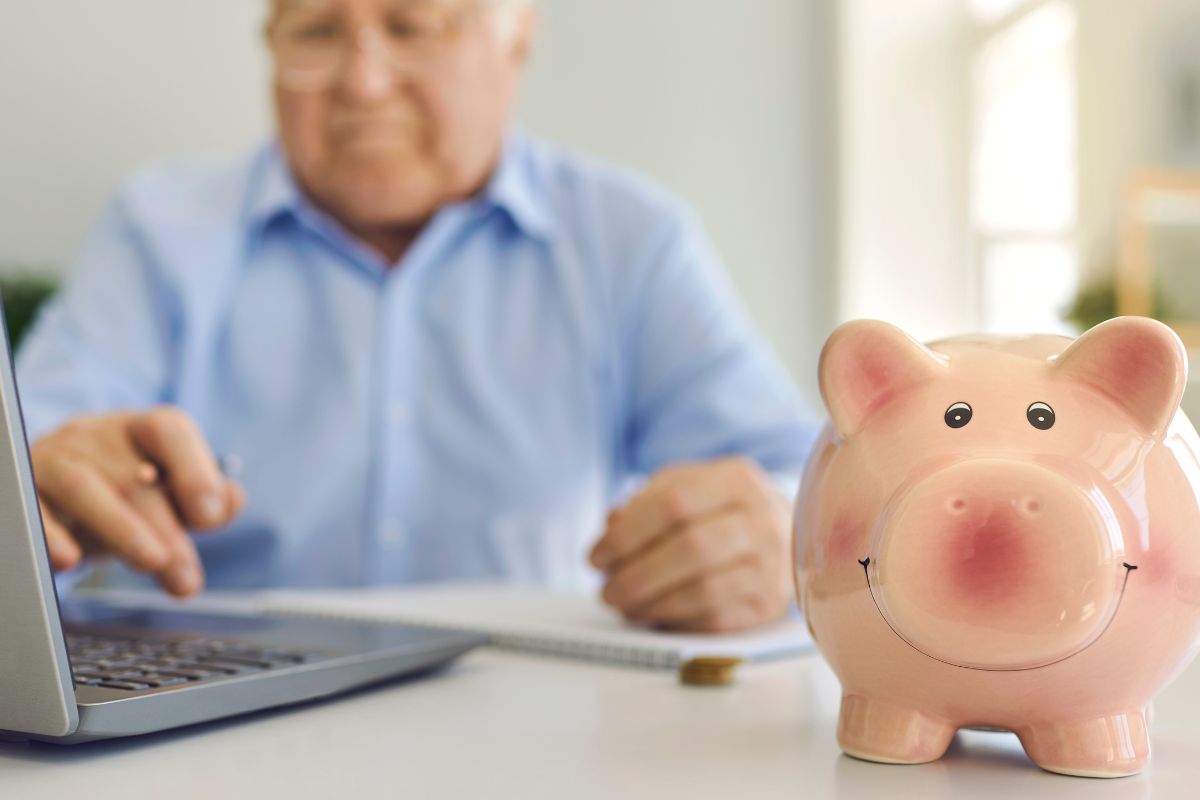 A picture of an old person and a piggy bank. 