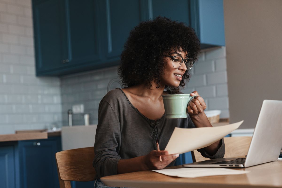 A picture of someone smiling while drinking their coffee.