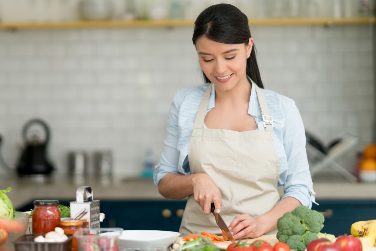 A picture of someone chopping carrots.