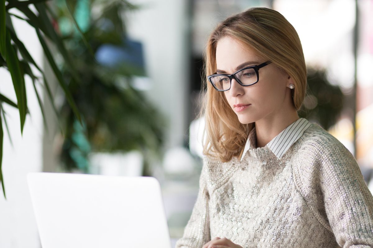 A picture of someone working in her laptop. 