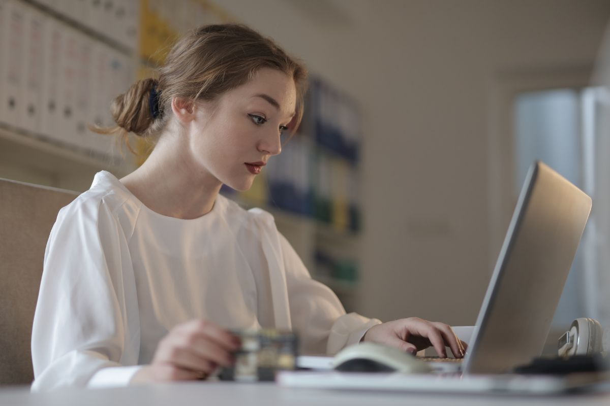 A picture of someone working using a laptop. 