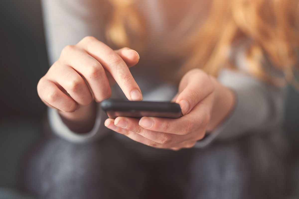A picture of someone using their phone. 