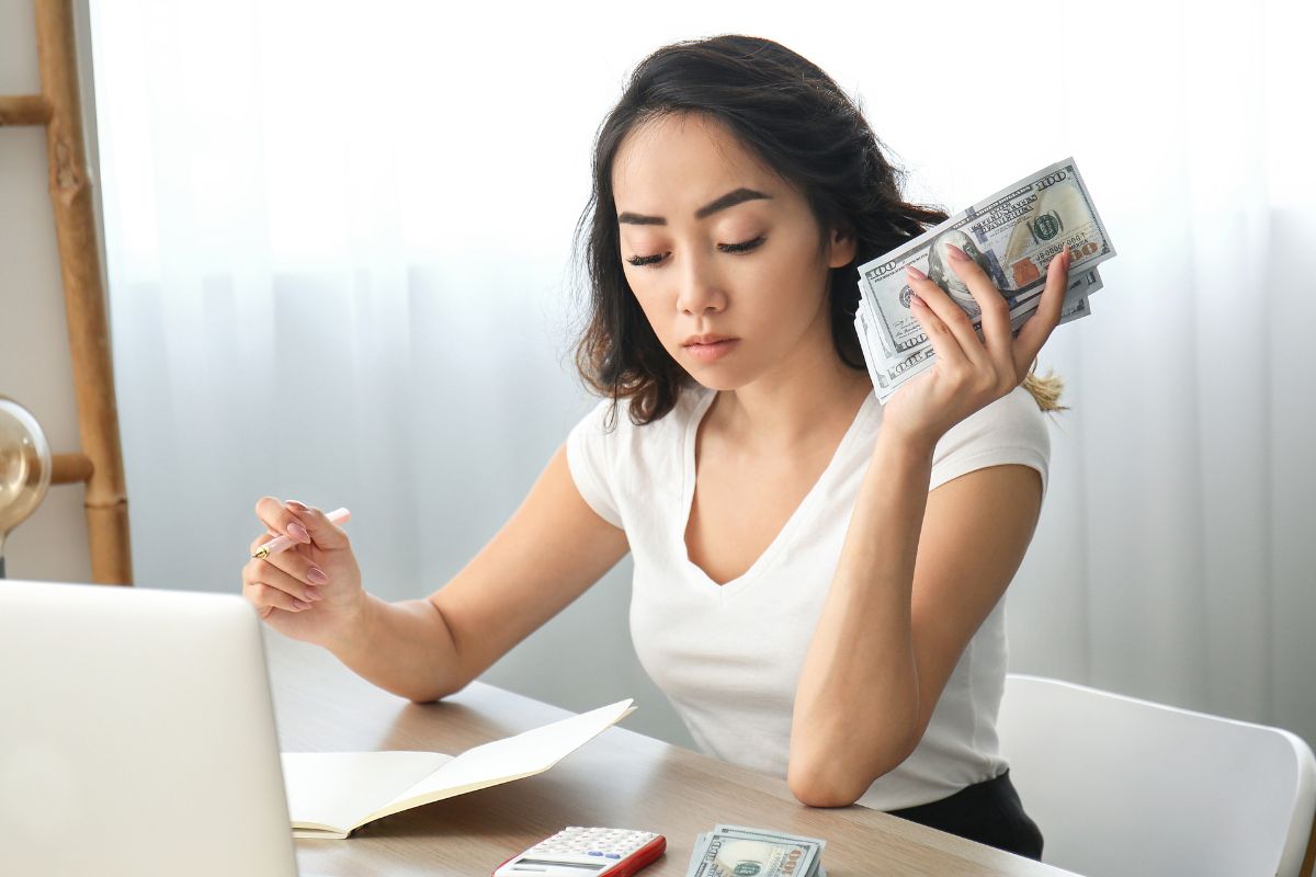 A picture of someone counting their money. 