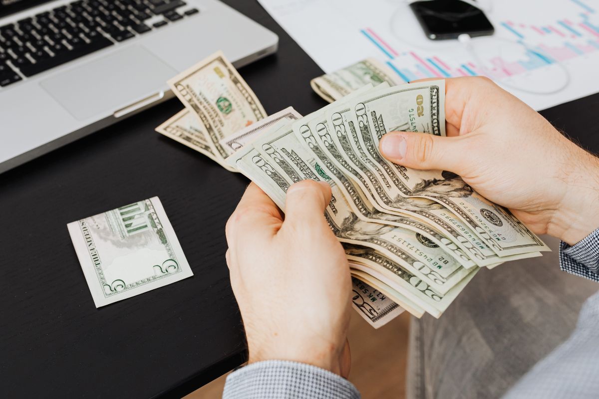 A picture of someone counting money. 