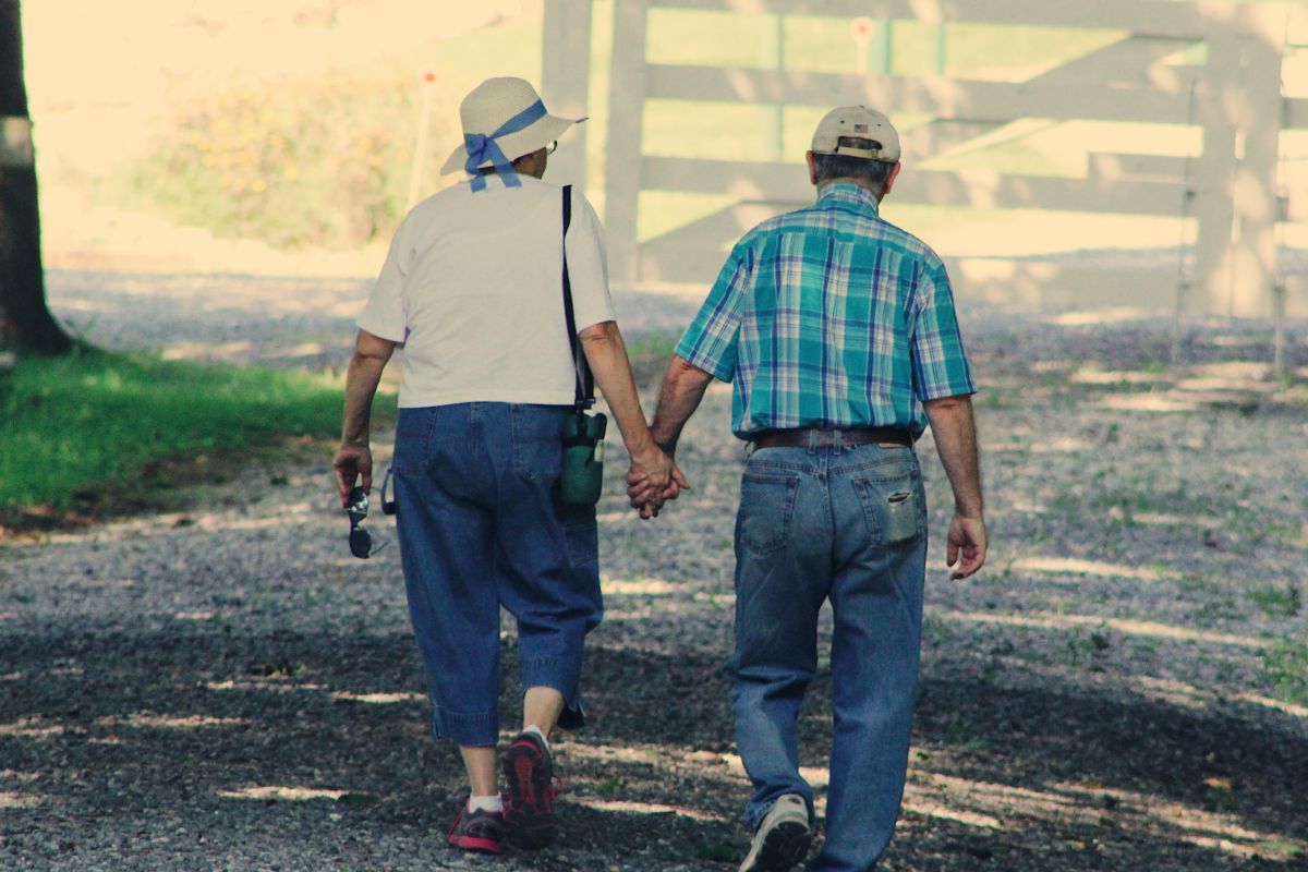 A picture of an old couple walking together. 