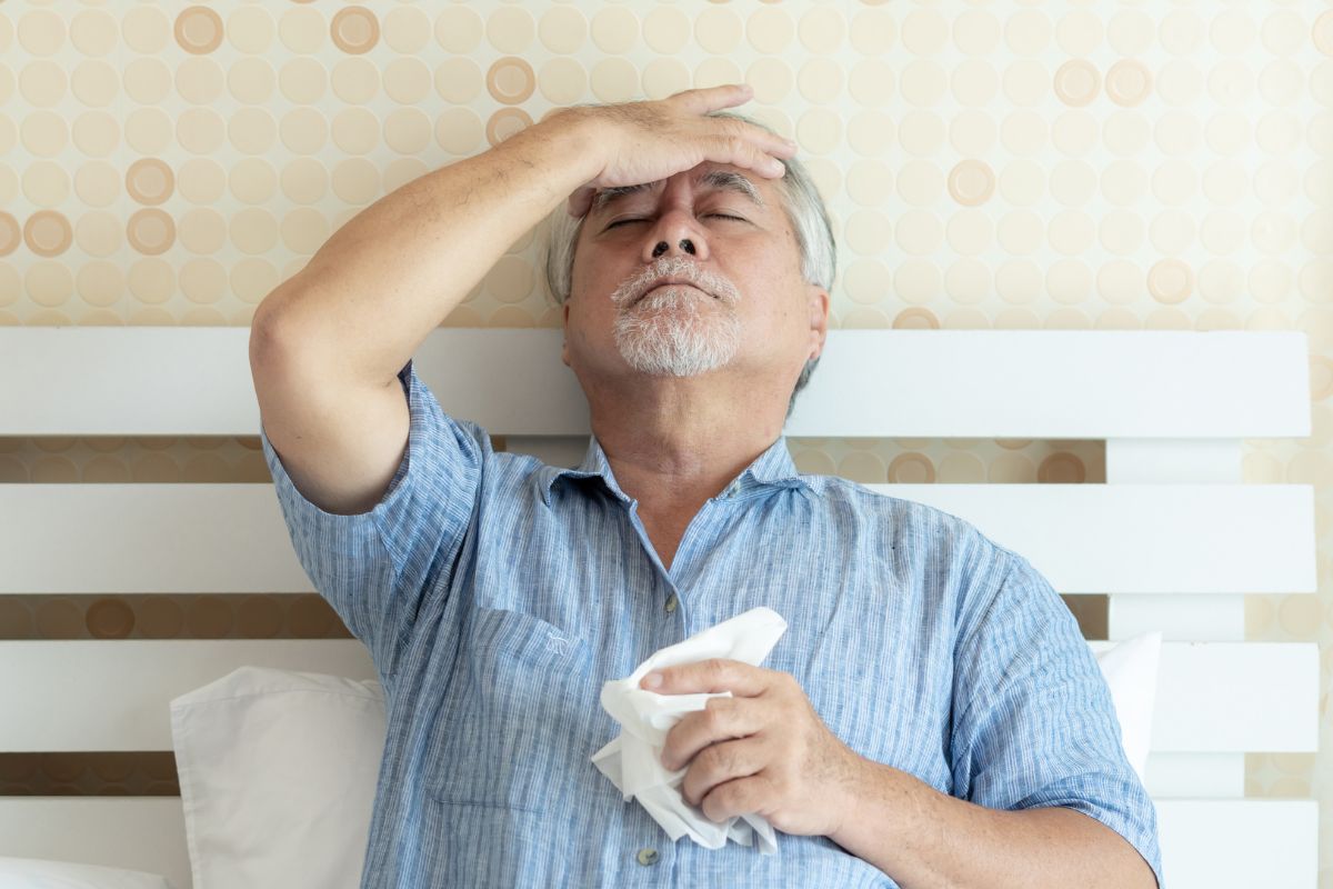 A picture of an old person with a headache. 