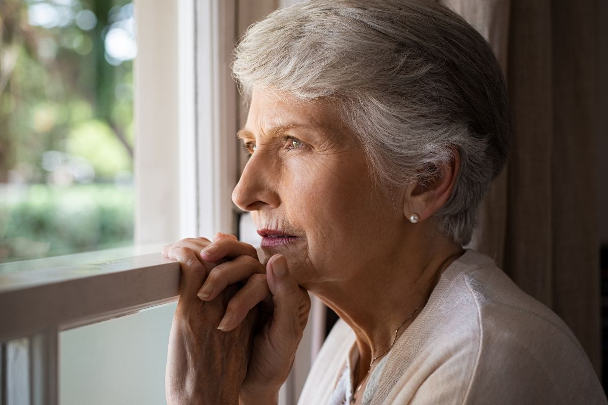 A picture of someone looking at outside. 