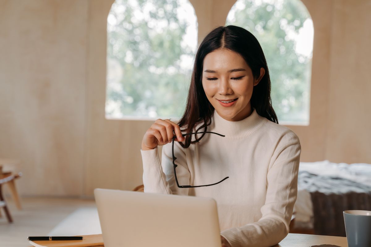 A picture of someone looking at her laptop. 
