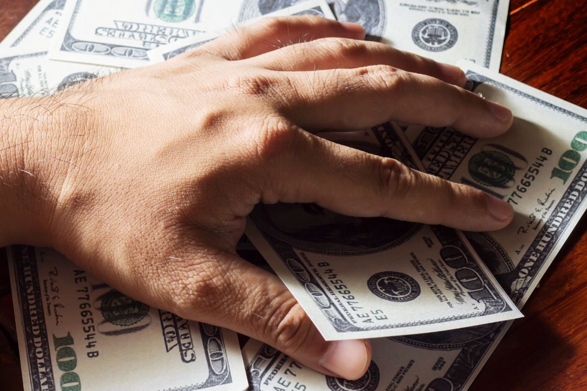 A picture of someone holding their money. 