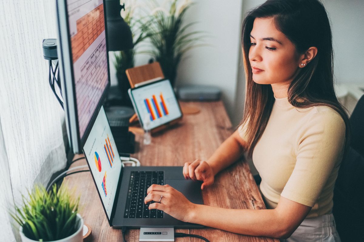 A picture of someone looking at their laptop. 
