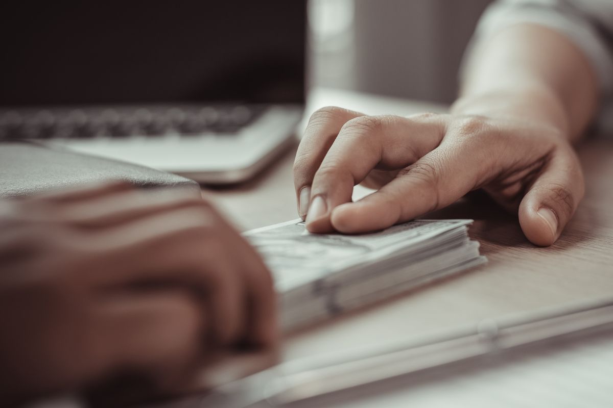 A picture of someone paying their debt. 