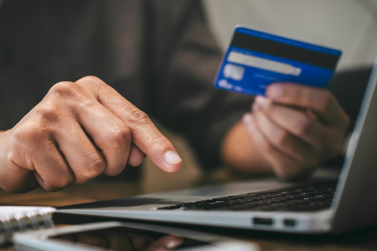 A picture of someone using their credit card online.