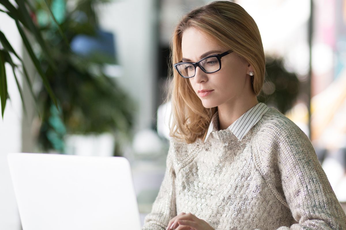 A picture of someone looking at her laptop. 