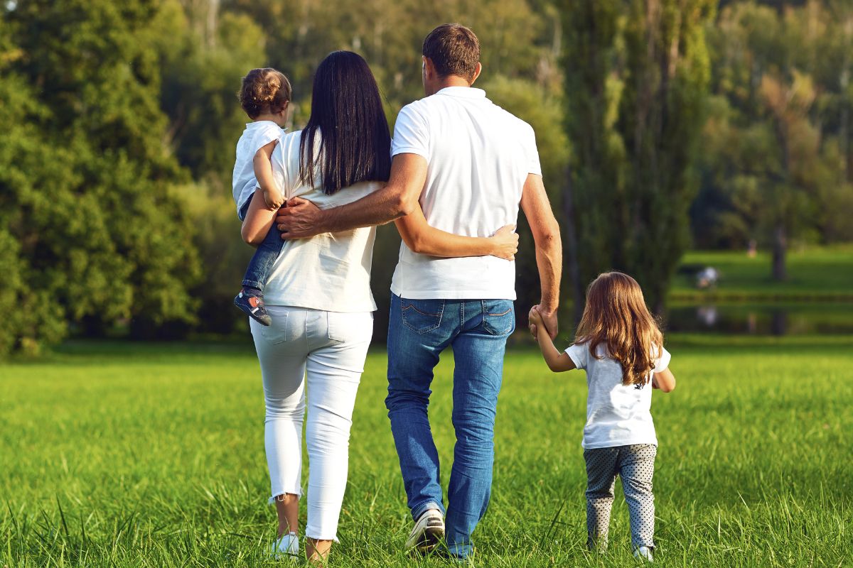 A picture of a family walking to a park. 