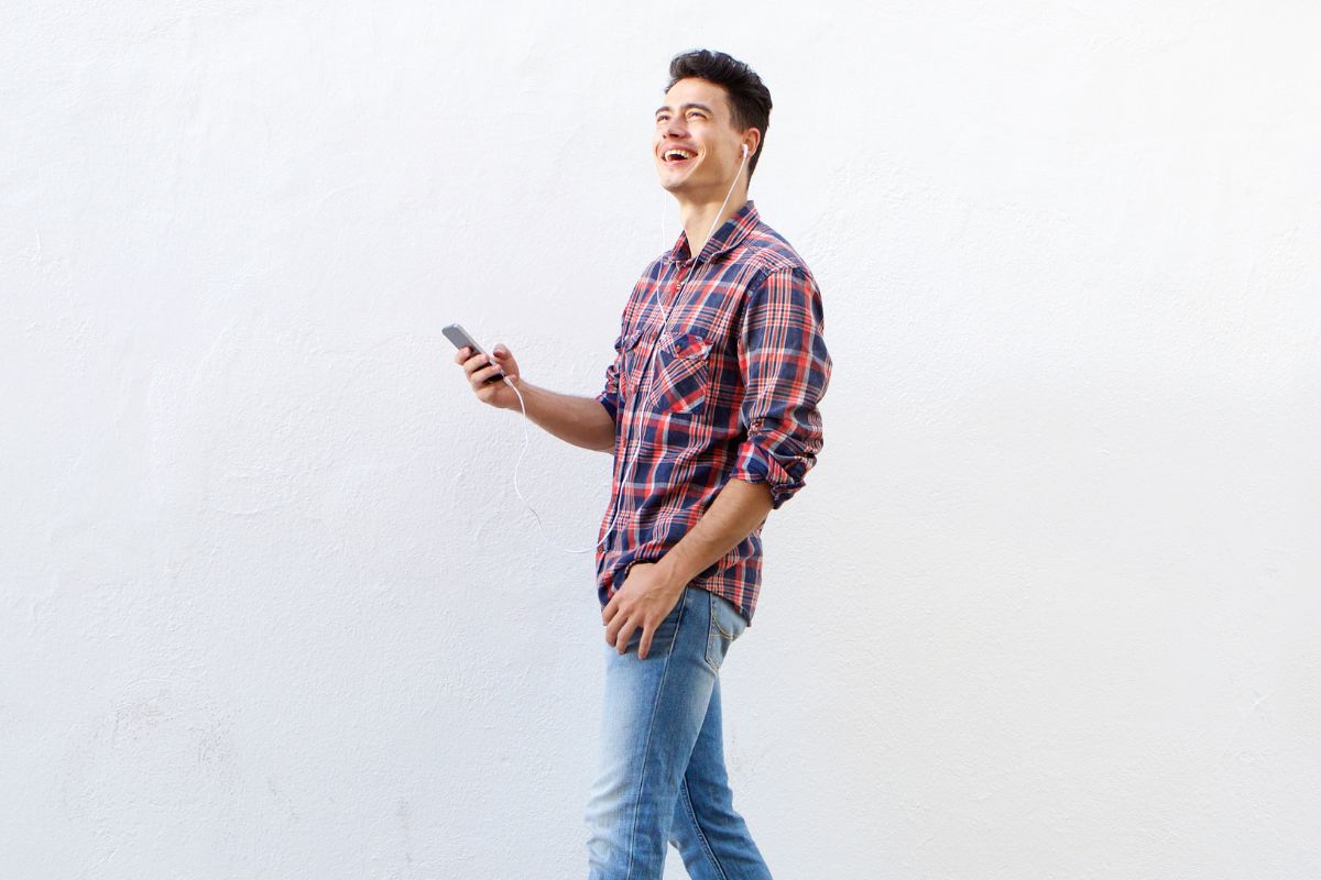 A picture of someone walking while smiling. 