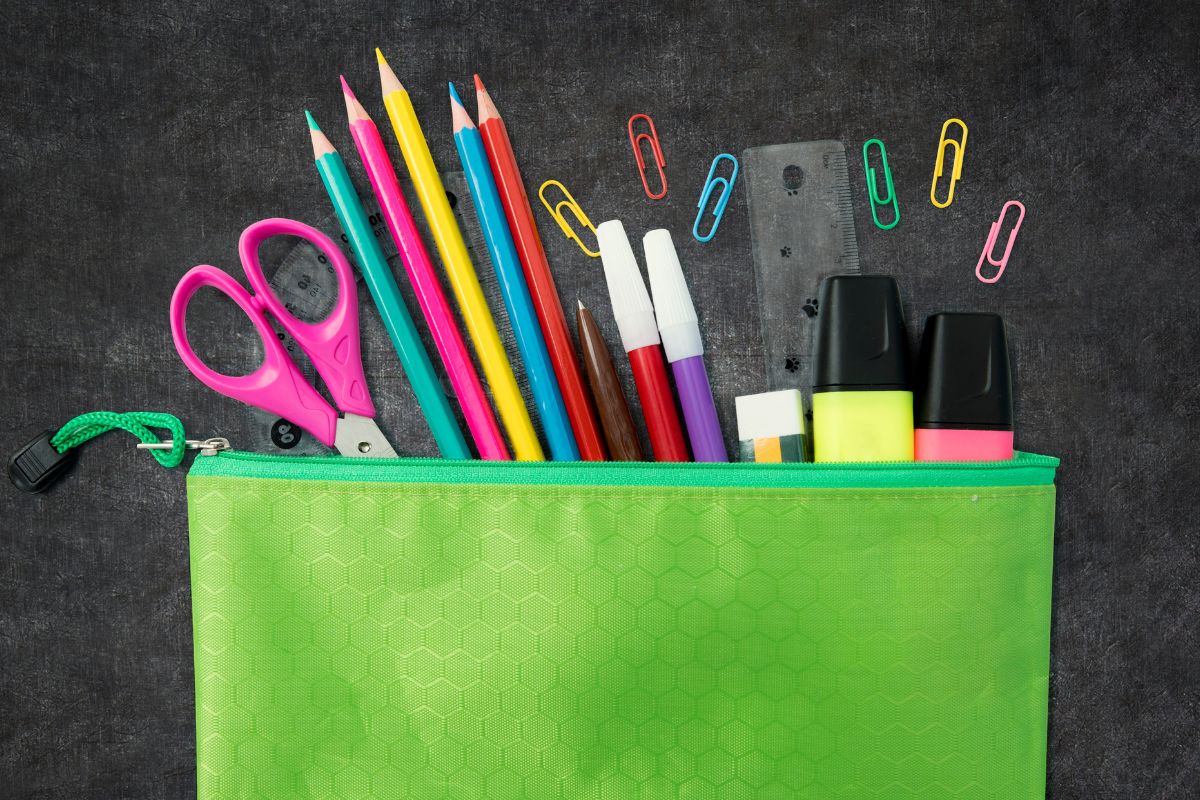 A picture of a pencil pouch with school supplies. 