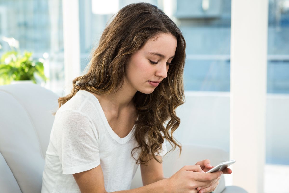 A picture of someone using their phone. 