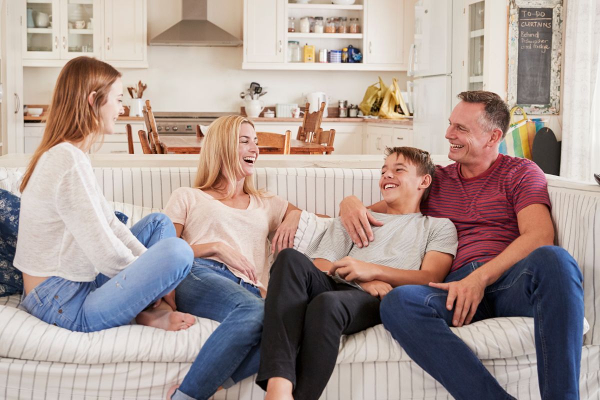 A picture of a family on a sofa.