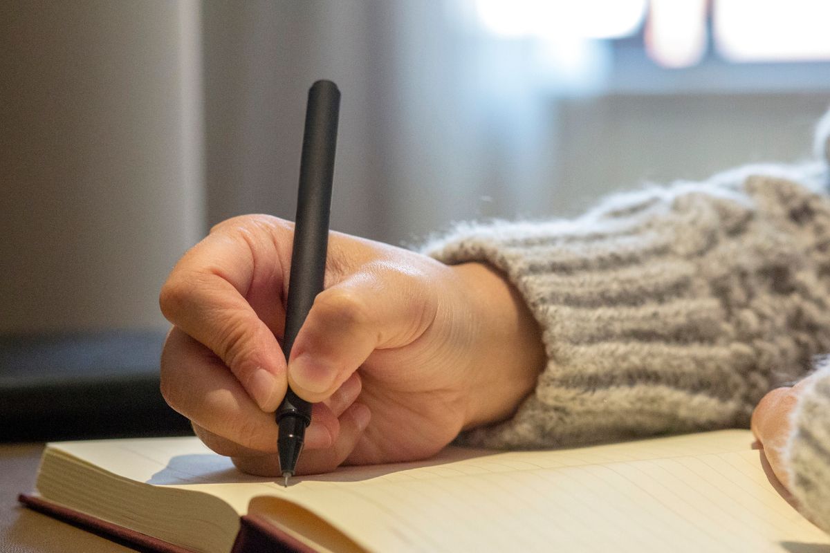 A picture of someone writing something. 